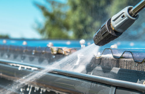 Close up photo of Gutters Cleaning Using Pressure Washer